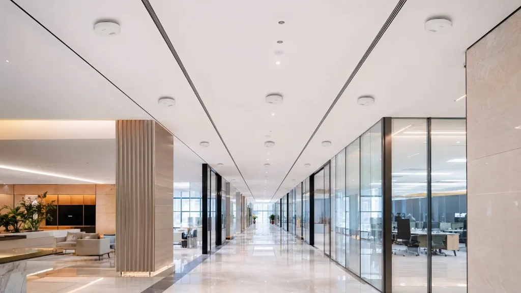 Ceiling DAS antennas installed across a modern office corridor for indoor 5G coverage