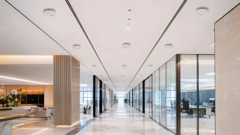 Ceiling DAS antennas installed across a modern office corridor for indoor 5G coverage