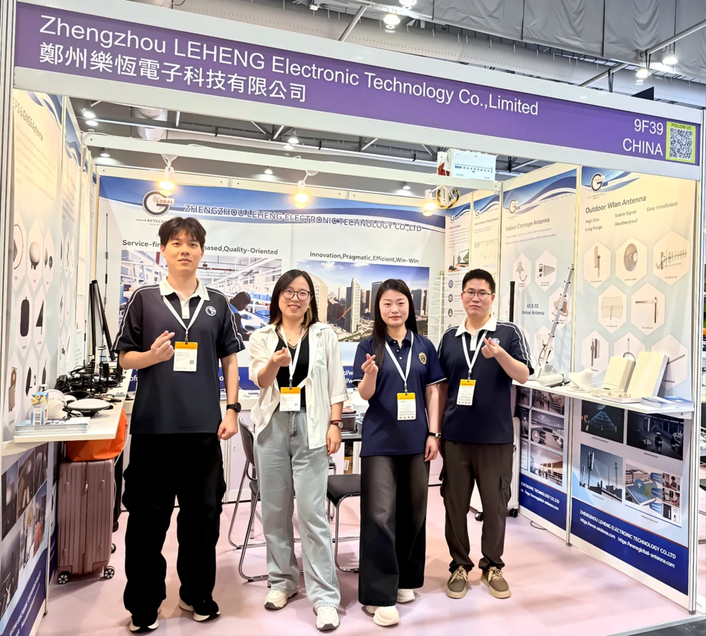 Global RF Tech exhibition team standing in front of the company booth in Hong Kong.