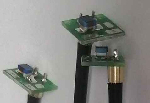 Close view of black coaxial cable assemblies and PCB-mounted terminations